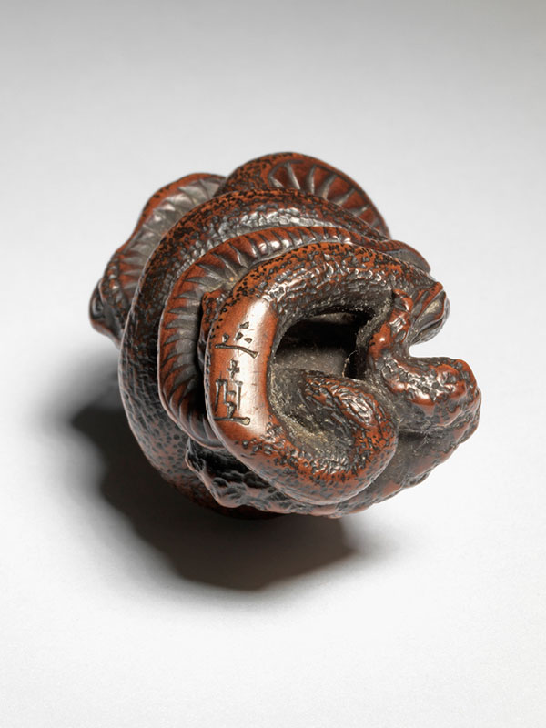 Masanao - wood netsuke of a snake and toad locked in mortal combat